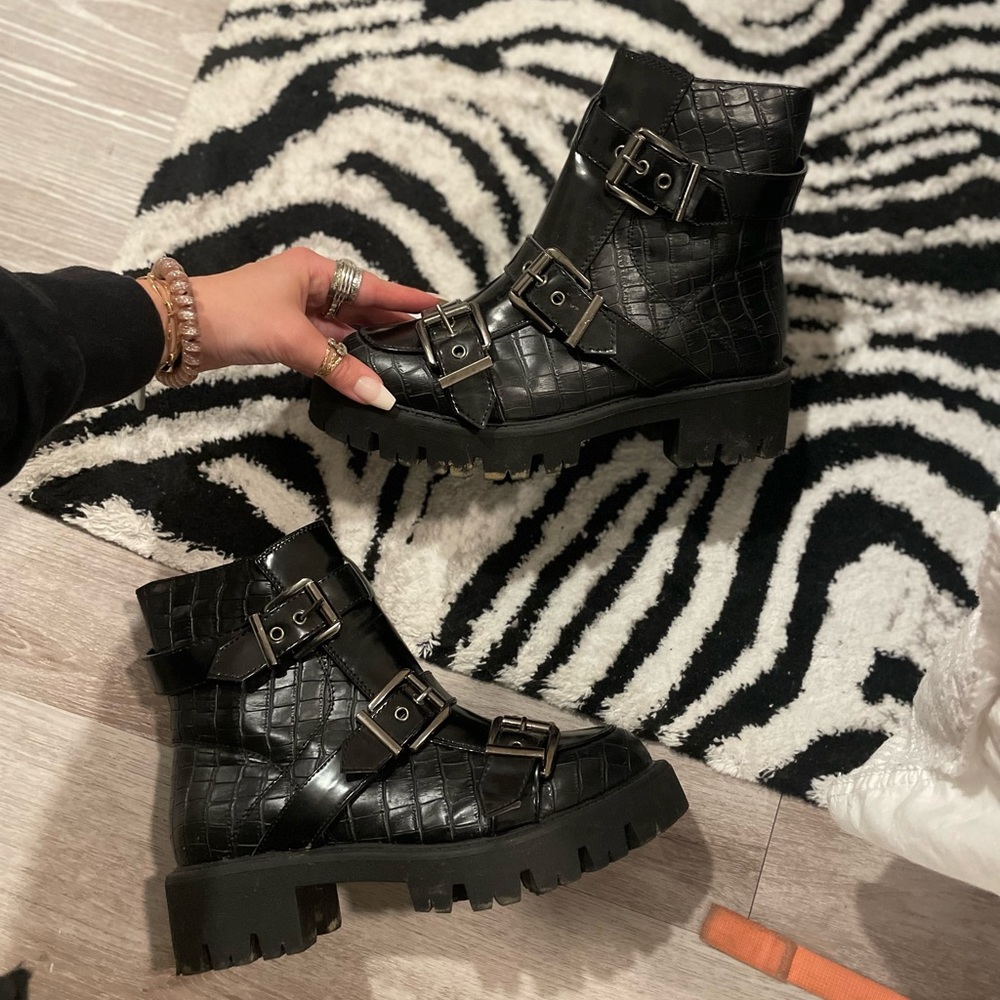 Chunky black crocodile boots with accent buckles